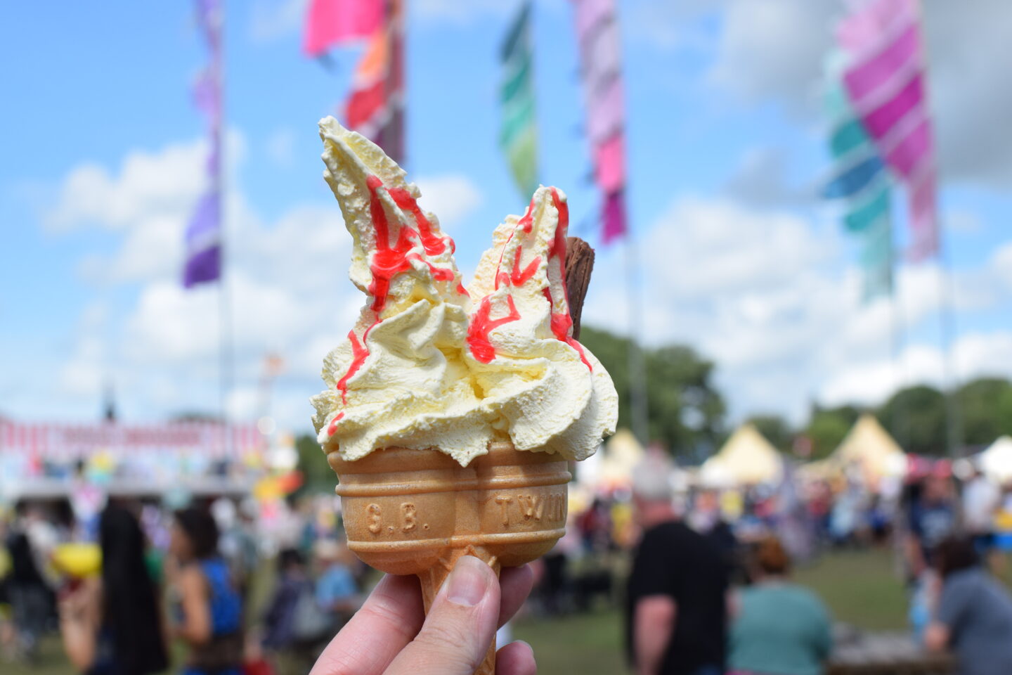 Ice cream in the sunshine with a festival backdrop