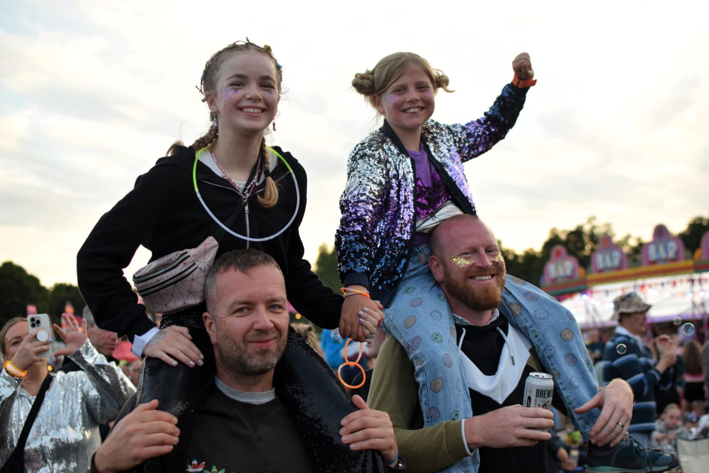 Amy and Ruby on their Dad's shoulders watching Groove Armada