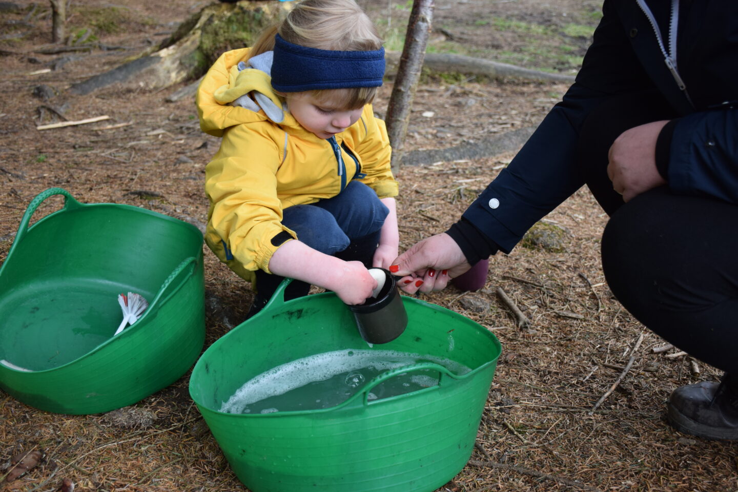 Three year old Amy doing the washing up when we were camping in the woods