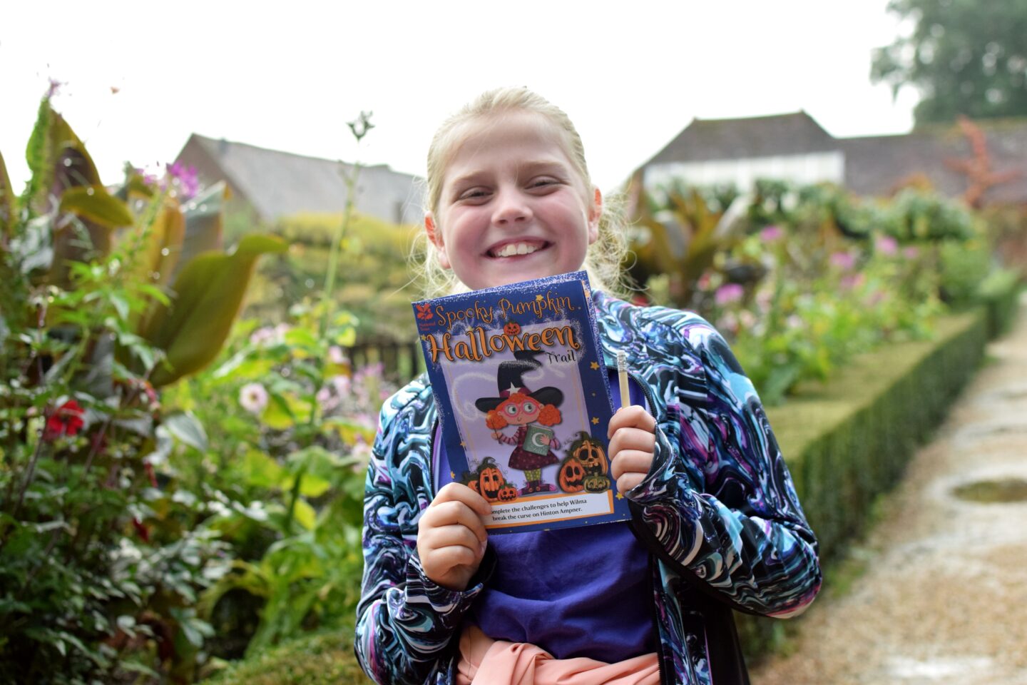 National Trust Hinton Ampner - Amy holding the Pumpkin Trail sheet with a big smile on her face.