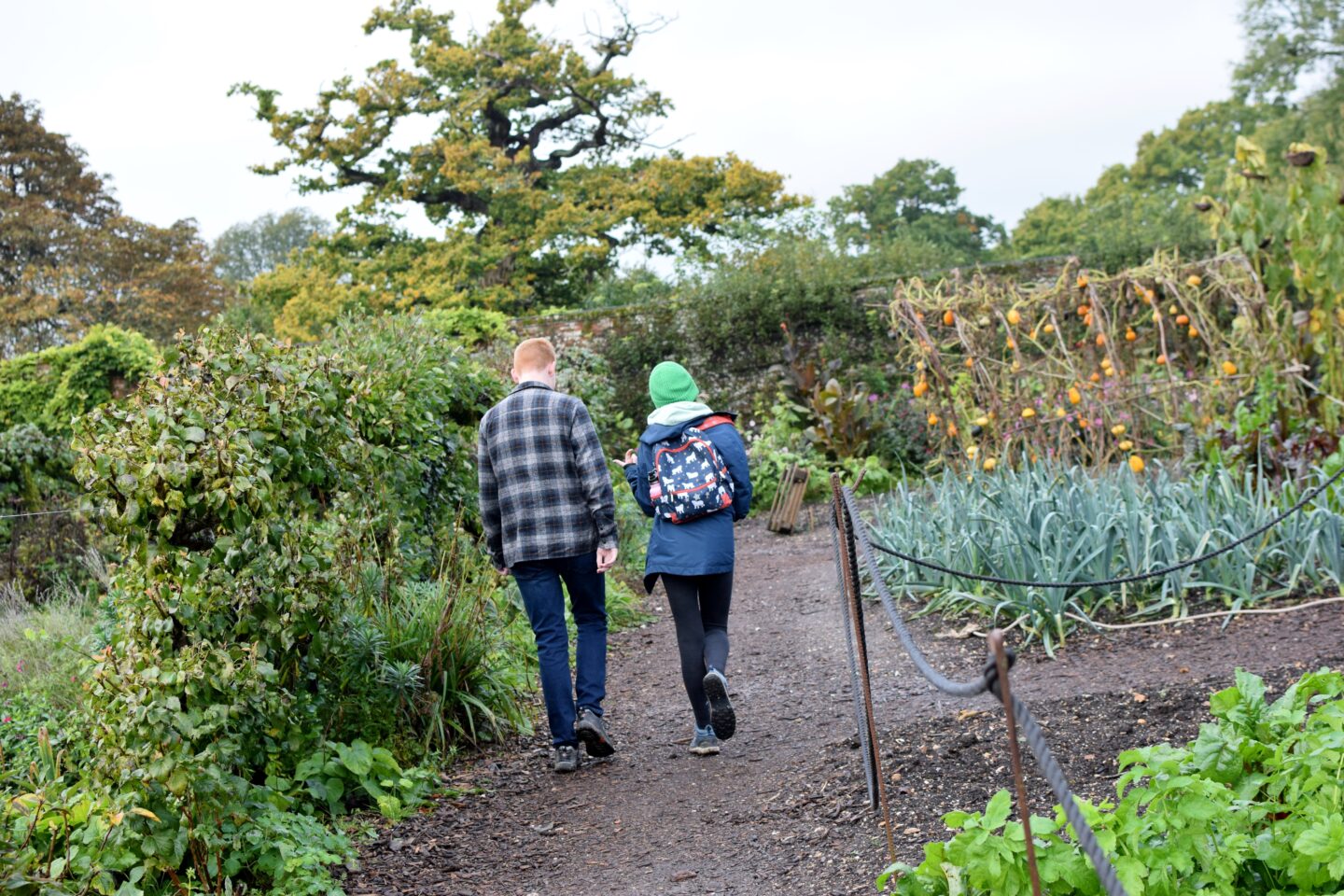 Ben and Chloe deep in conversation walking around the gardens