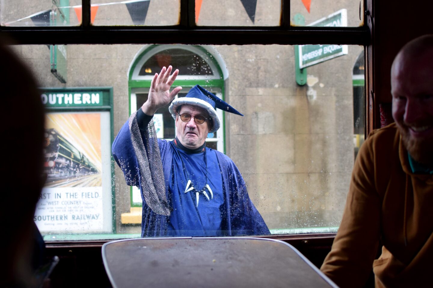 Wizard Week wizard waving at us through the train window