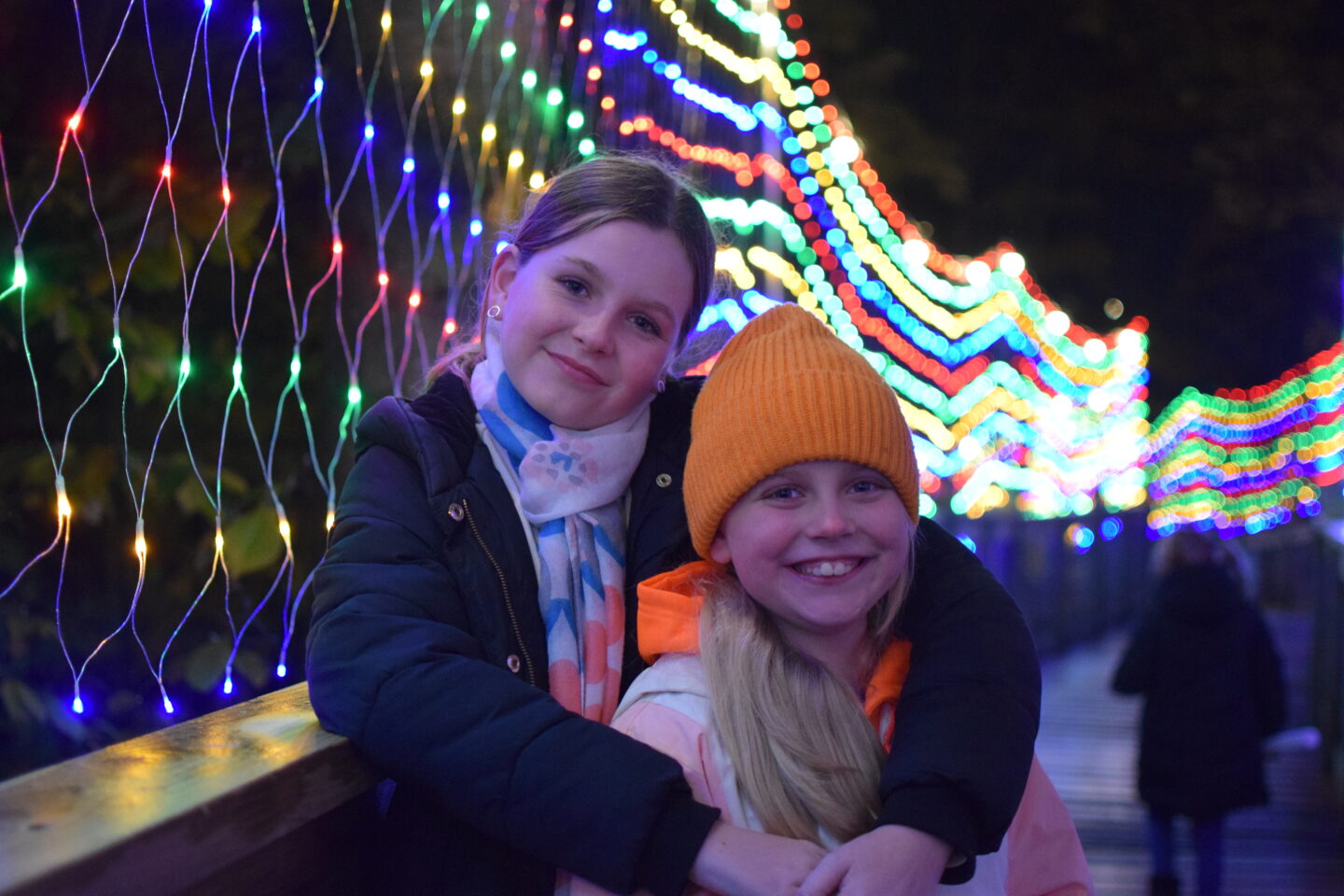 Amy and Chloe in a twinkly corridor of lights