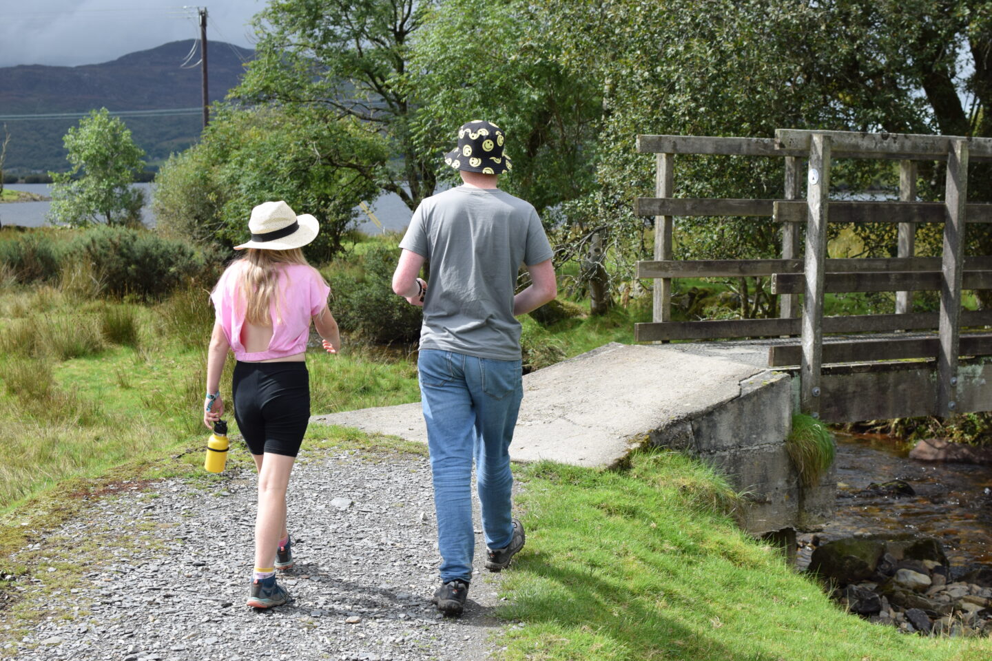 Ben and Amy walking in the summer, wearing hiking shoes to protect their feet
