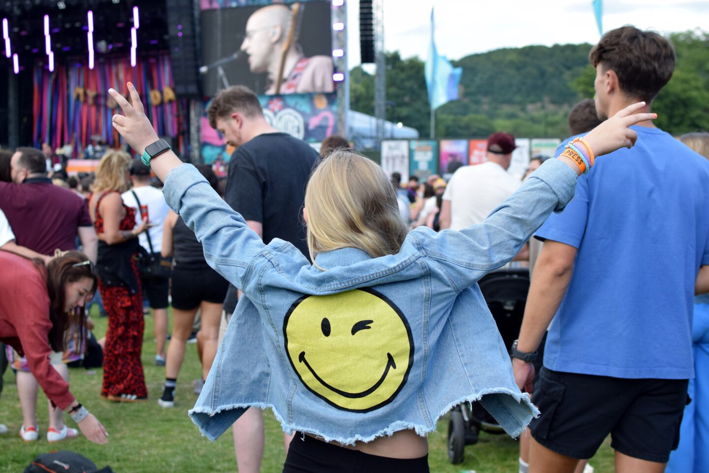 Amy wearing a smiley denim jacket from Vinted at a festival