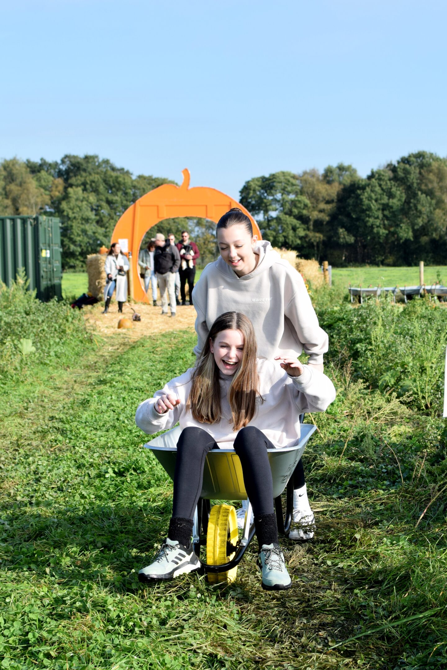 Chloe and Willow messing about with the wheelbarrows at the pumpkin patch
