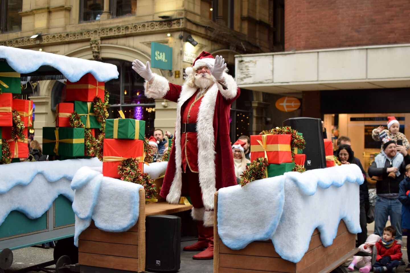 Father Christmas waving at the crowds from his float during the Manchester Christmas Parade