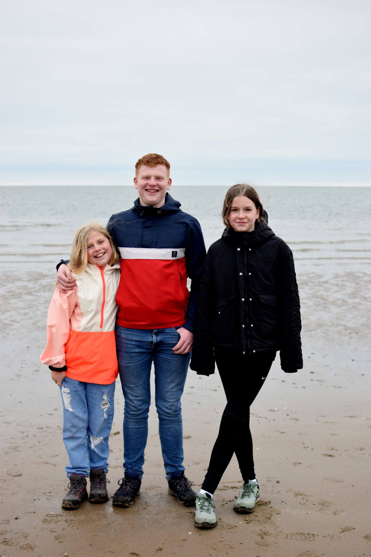 Amy, Ben and Chloe posing for a photo together on Conwy Morfa Beach
