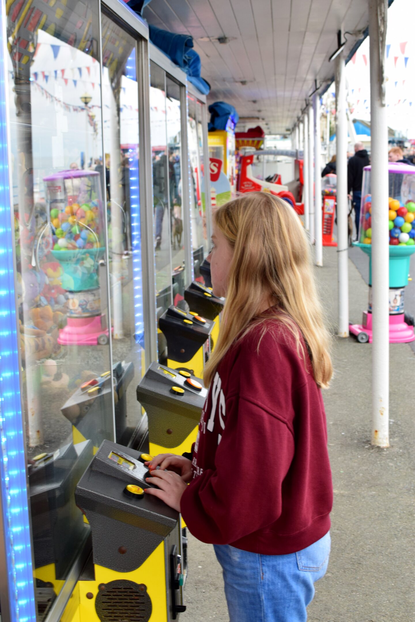 Amy playing grab machines on Llandudno Pier