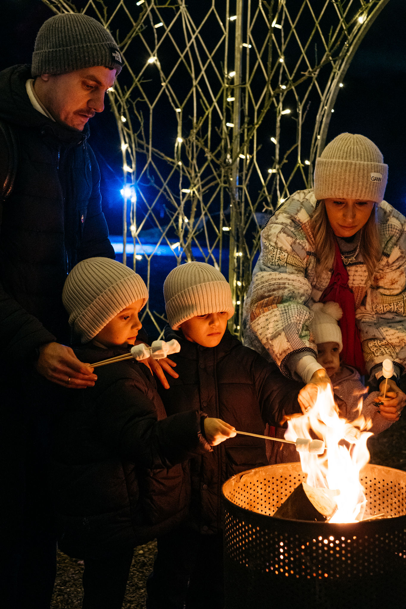 Family toasting marshmallows on the Yuletide campfire at Tatton Park