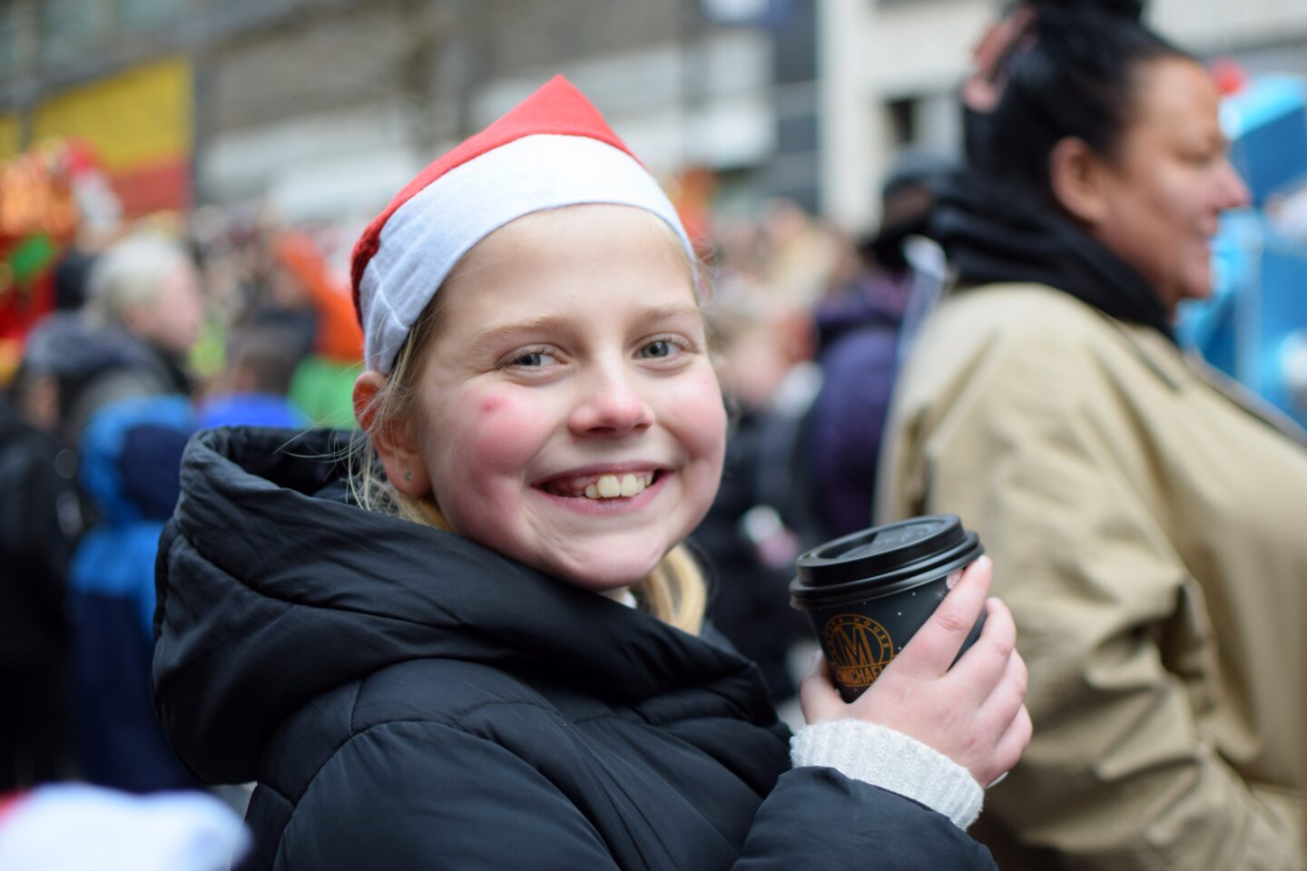 Amy drinking hot chocolate and watching the Manchester Christmas Parade