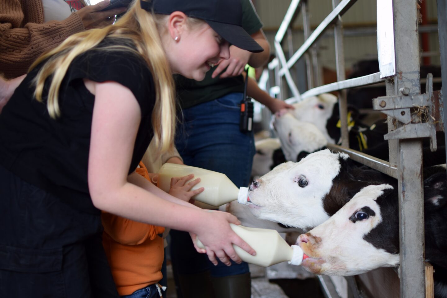 Amy beaming whilst feeding calves