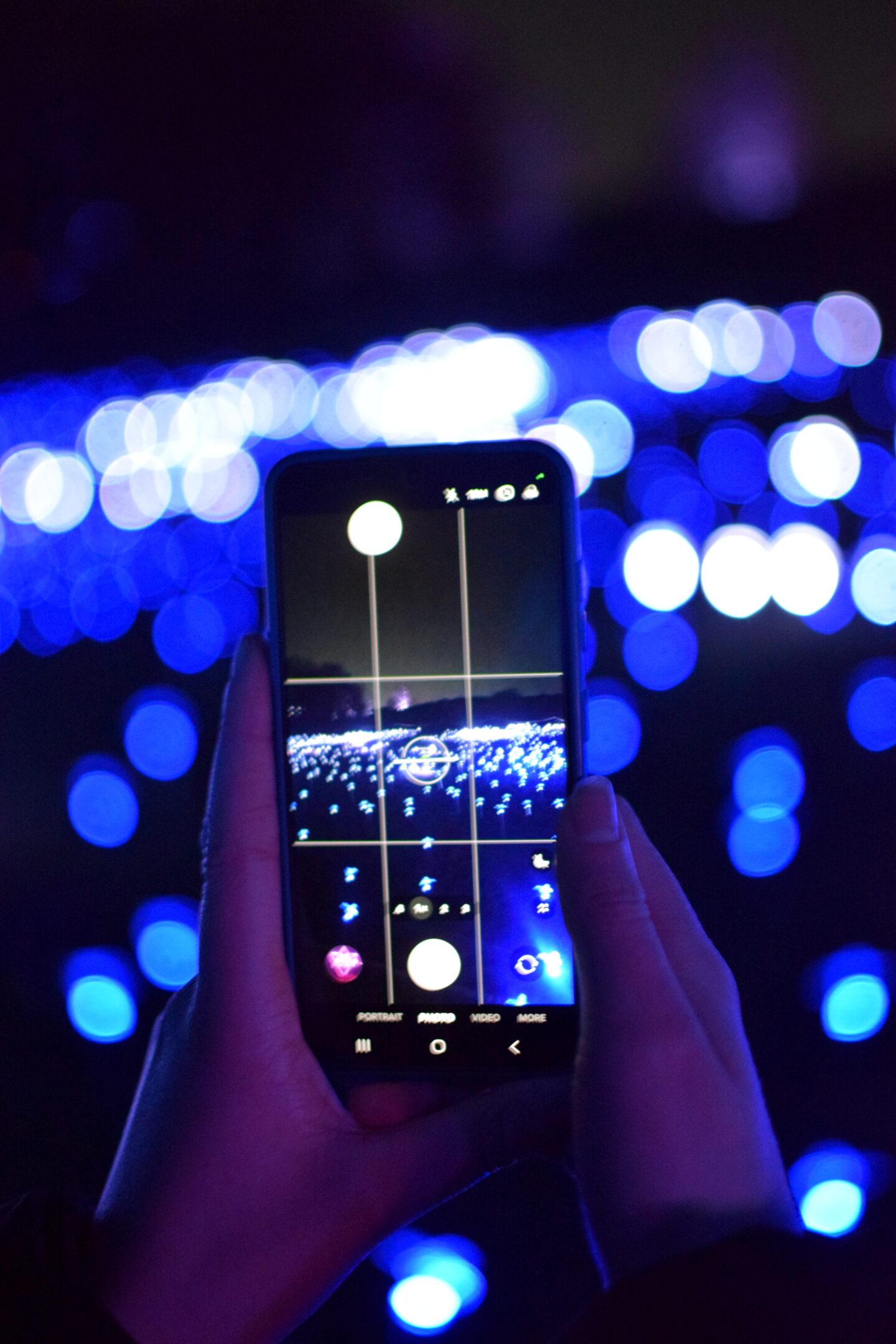 Festive lights shown through a phone - Northern Lights Manchester